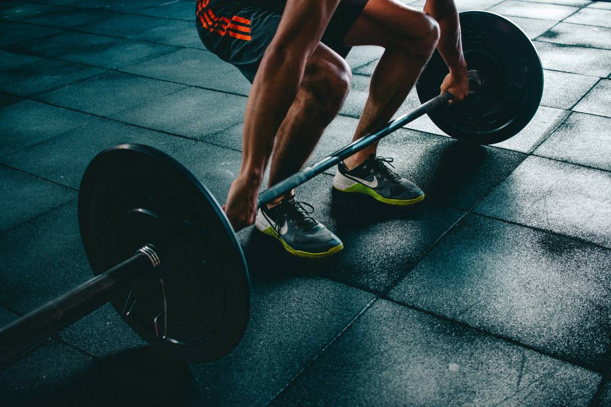 Woman performing kettlebell swings in home gym as part of power kettlebell workout plan