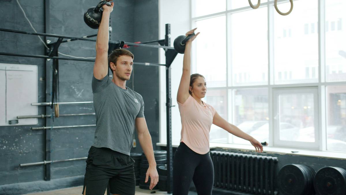 Man executing kettlebell swing as part of kettlebell fat loss exercise routine
