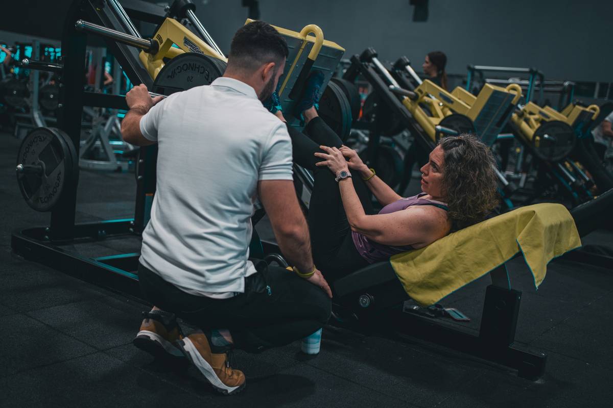 Woman performing kettlebell swing as part of iron burn session routine
